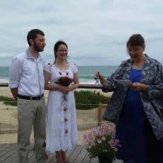 Perth celebrant Ishara rings a bell at a seaside wedding ceremony at City Beach